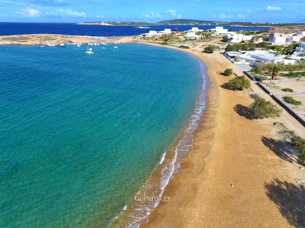 Agioi Anargyroi Beach, Paros, aerial view along the sandy shoreline with gentle waves and clear green-blue water