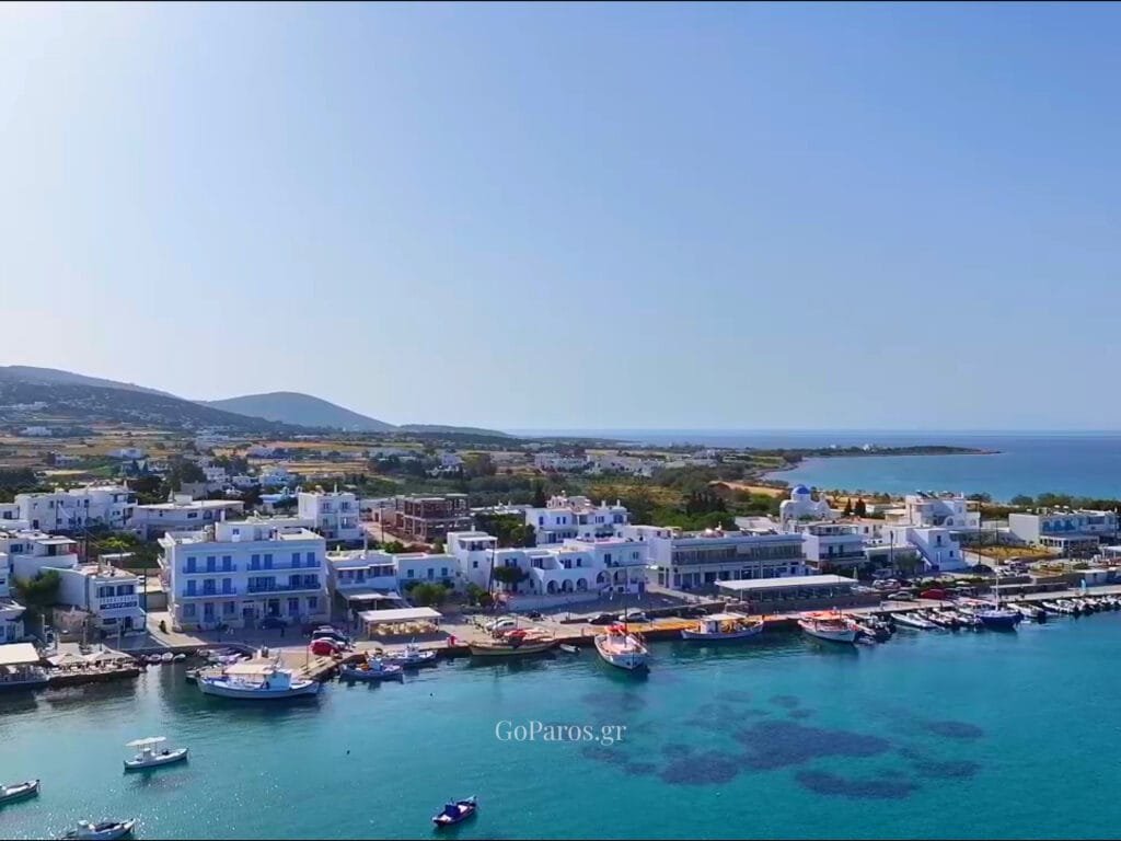 Aliki, Paros, close-up of fishing boats tied along the quay with winches, ropes, and reflections in the water