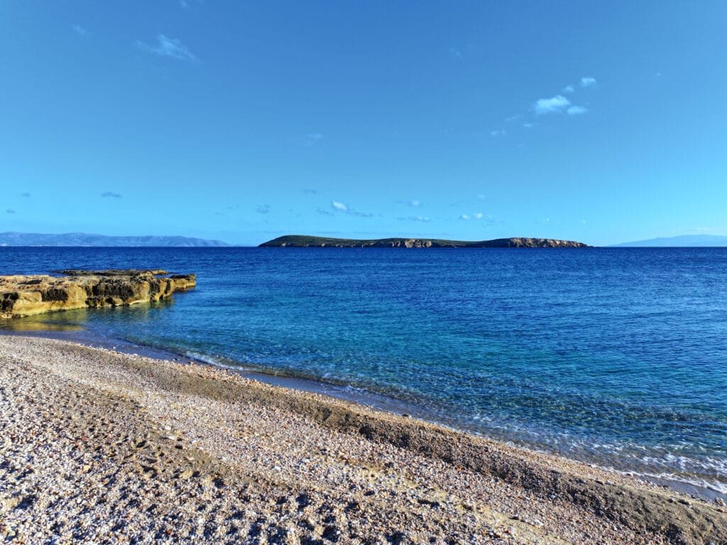 Long sandy shoreline with shallow clear water at Drios Beach, Paros.