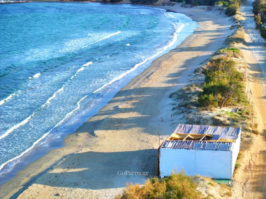 Aerial view of the sandy beach and dunes at Molos Beach, Paros.