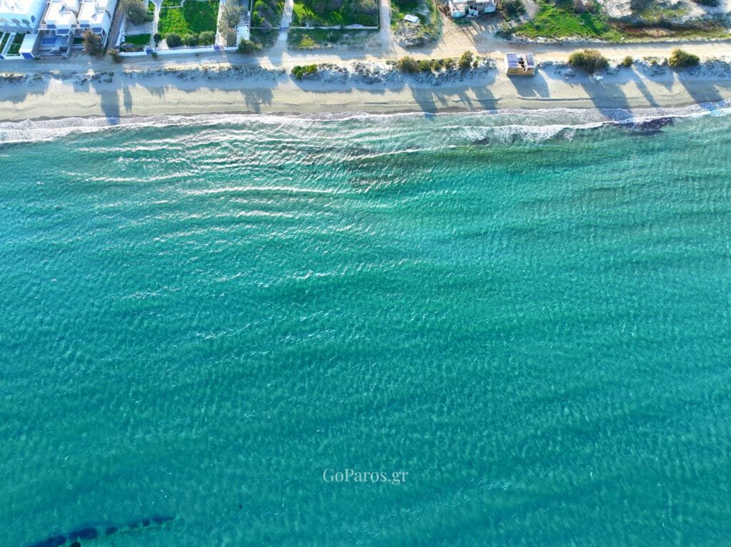 Top down aerial of turquoise shallows near Molos Beach, Paros.