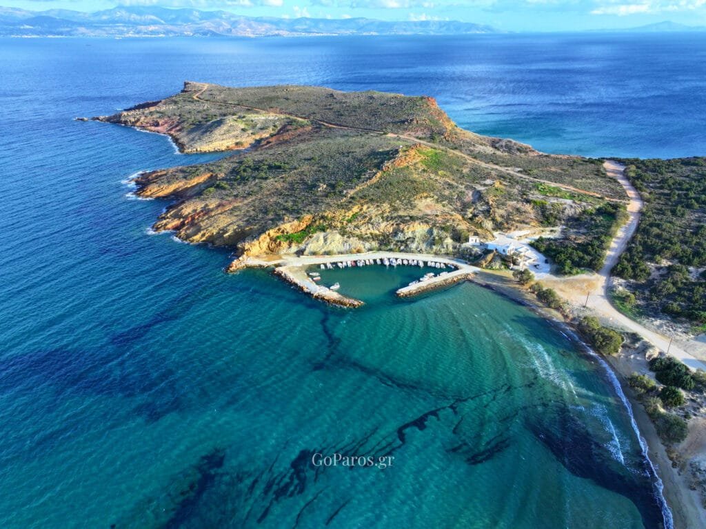 Rocky headland and small harbor near Molos Beach, Paros, seen from the air.