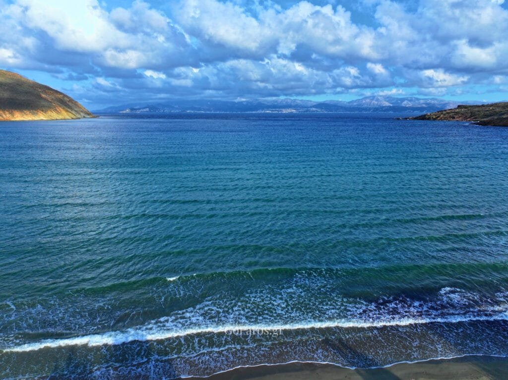 Sea horizon and gentle waves off Molos Beach, Paros, under dramatic clouds.