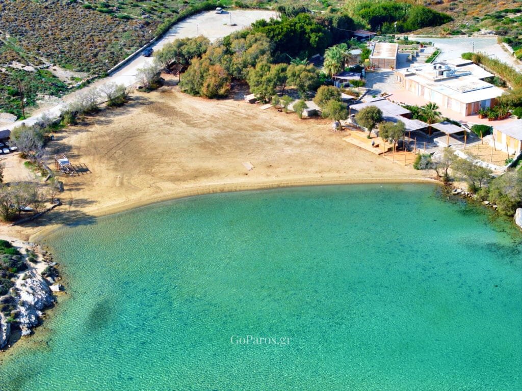 aerial view of monastiri beach bay in paros, with breakwater and turquoise water