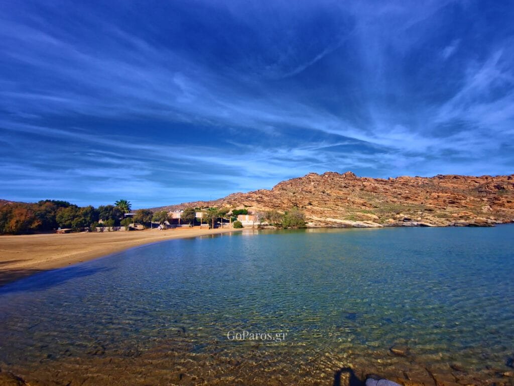 rocky shoreline and clear shallow water at monastiri beach, paros