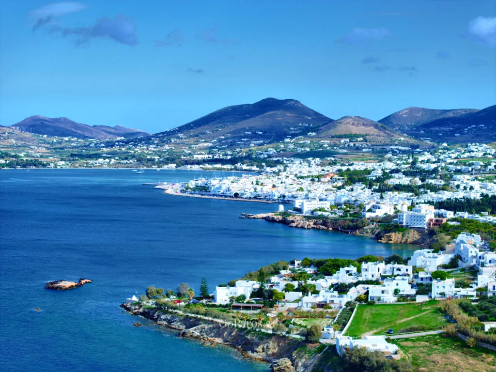 Parikia, Paros, panoramic view of the coastline and bay with whitewashed town and hills in the background