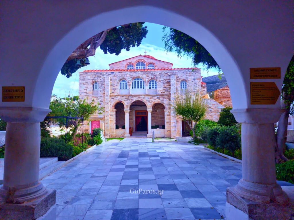 Parikia, Paros, stone church facade seen through an archway with a marble courtyard