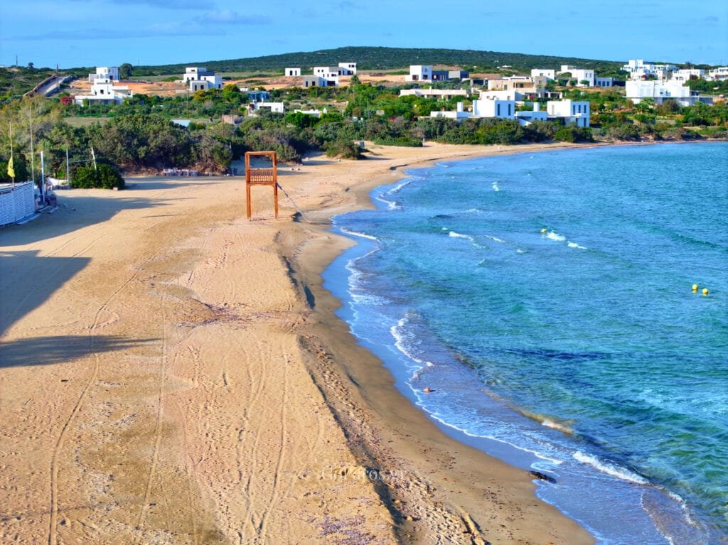 Bay with a wooden pier and rocky shoreline Santa Maria, Paros