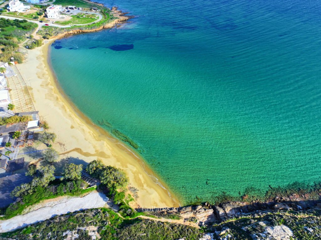 Aerial view of Punda Beach East bay in Paros, with turquoise water and a wide sandy shoreline.