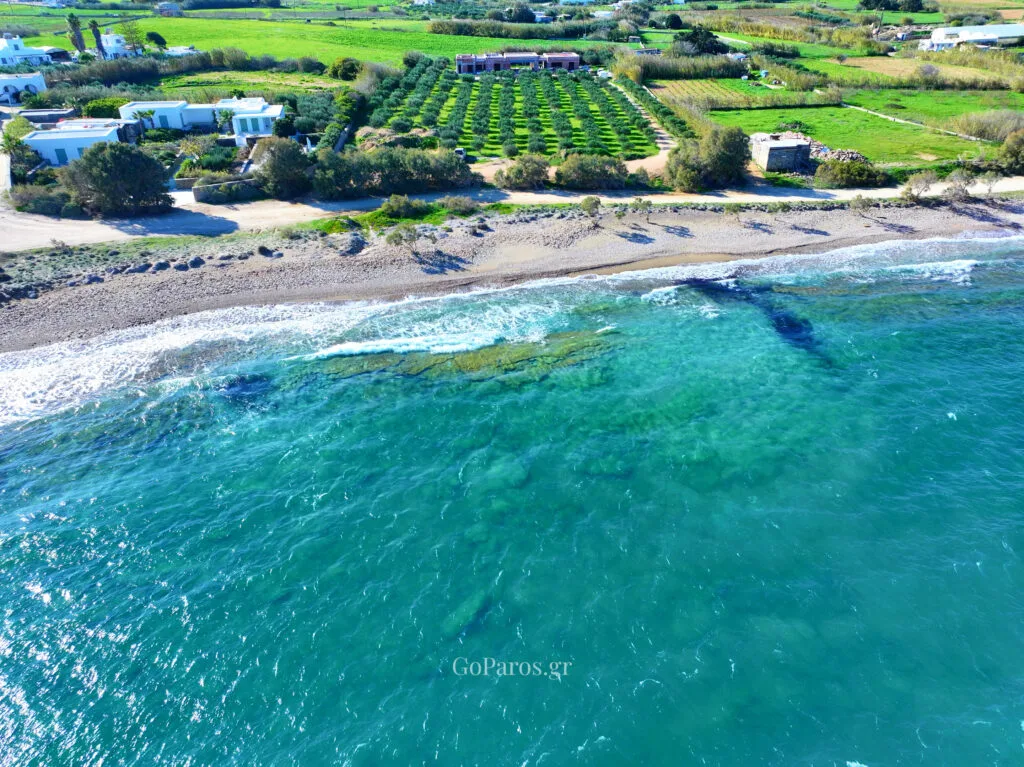 Aerial shot of Tsoukalia Beach, Paros with shallow reef patterns in clear water.