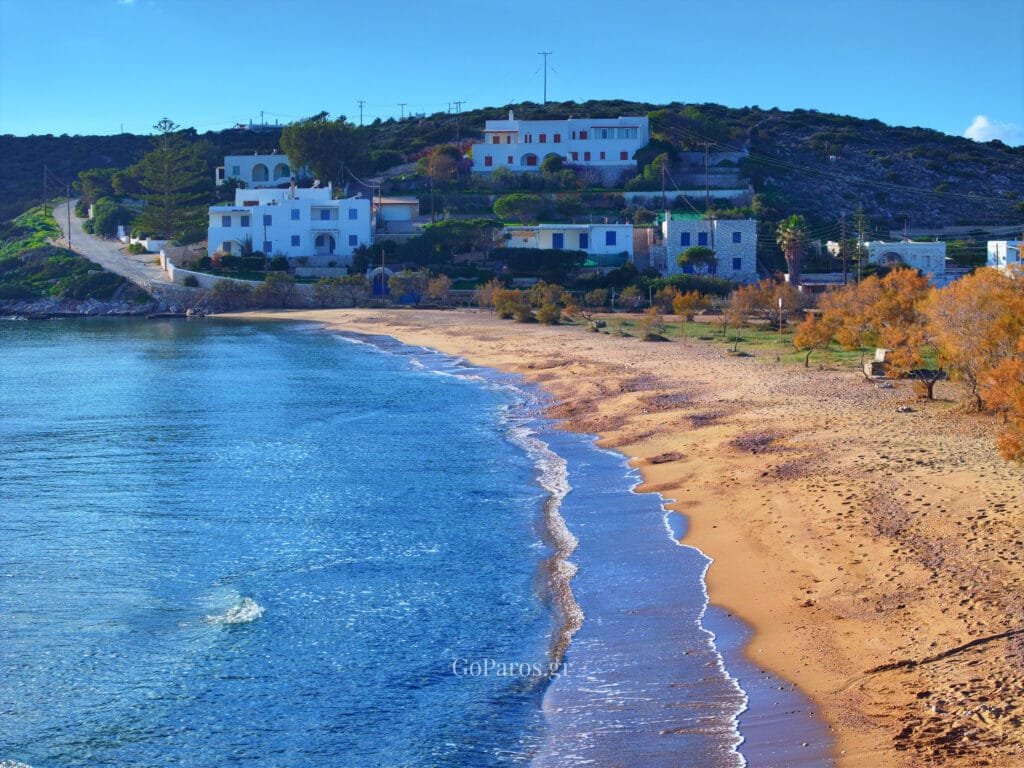 Agios Nikolaos Beach, Aliki, Paros, beach view with white Cycladic houses and hillside behind