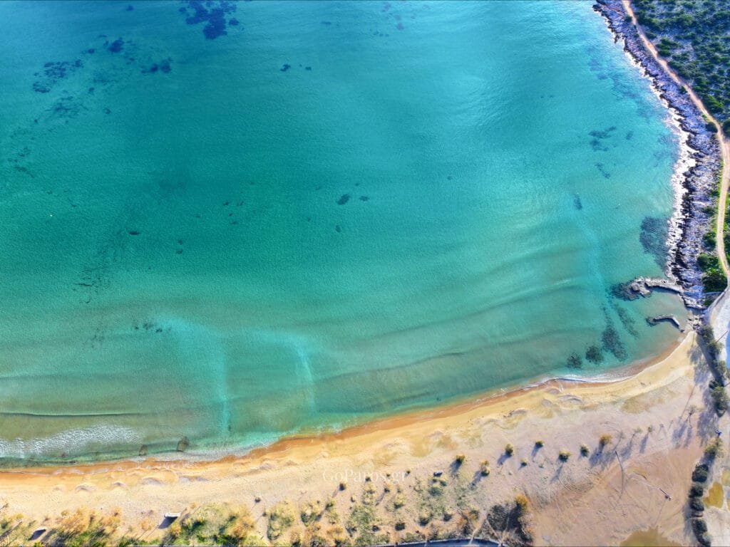 Agios Nikolaos Beach, Aliki, Paros, top-down drone shot of shoreline patterns and clear shallow water