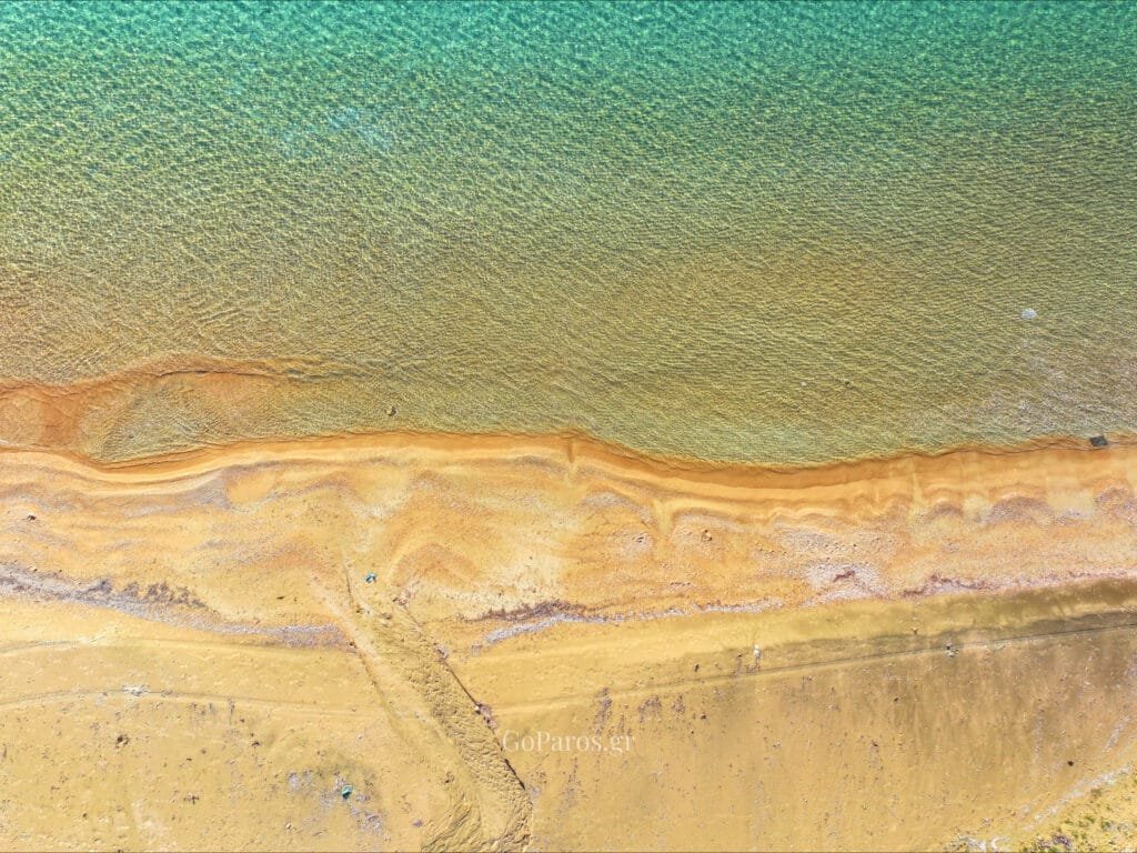 Aliki Beach, Paros, aerial view of the sandbar meeting the sea.