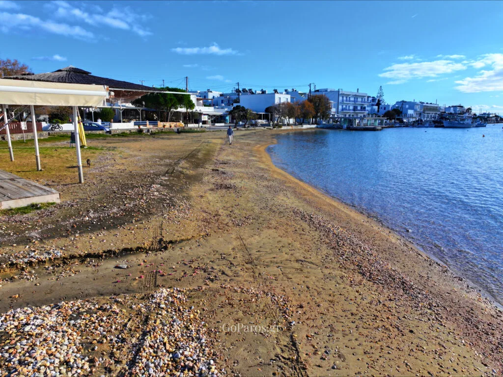 Aliki Beach, Paros, aerial view of beachfront umbrellas and a person walking along the shore