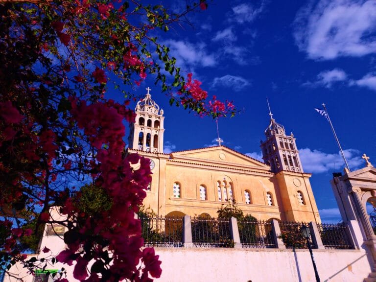 Lefkes, Paros, church facade with bougainvillea flowers against a deep blue sky