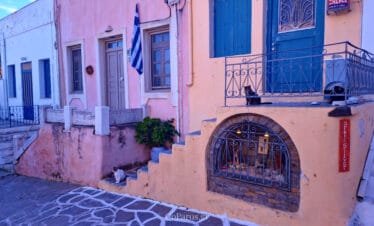 Lefkes, Paros, pastel village house with blue shutters and cats on a small terrace
