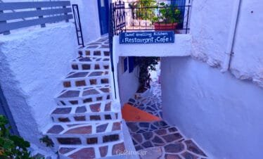 Lefkes, Paros, narrow steps and alleyway with a small restaurant cafe sign