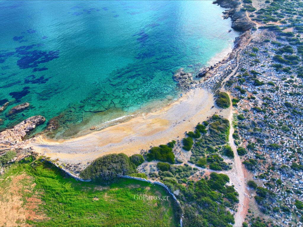Makria Miti Beach, Paros, aerial view of a turquoise cove with rocky shoreline and clear shallows