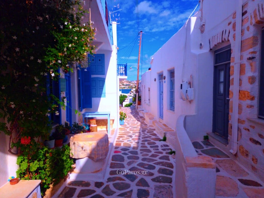 Parikia, Paros, whitewashed alley with blue shutters and sea view