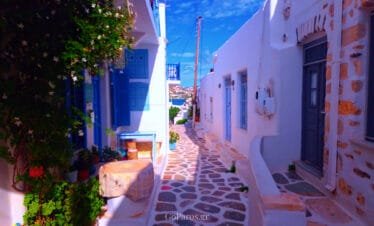 Parikia, Paros, whitewashed alley with blue shutters and sea view