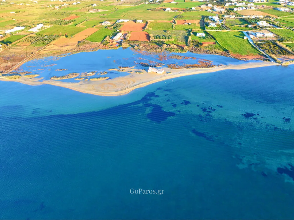 Pounda Beach West, Paros, wide aerial view of beach, lagoon, and shallow reef patches in the water