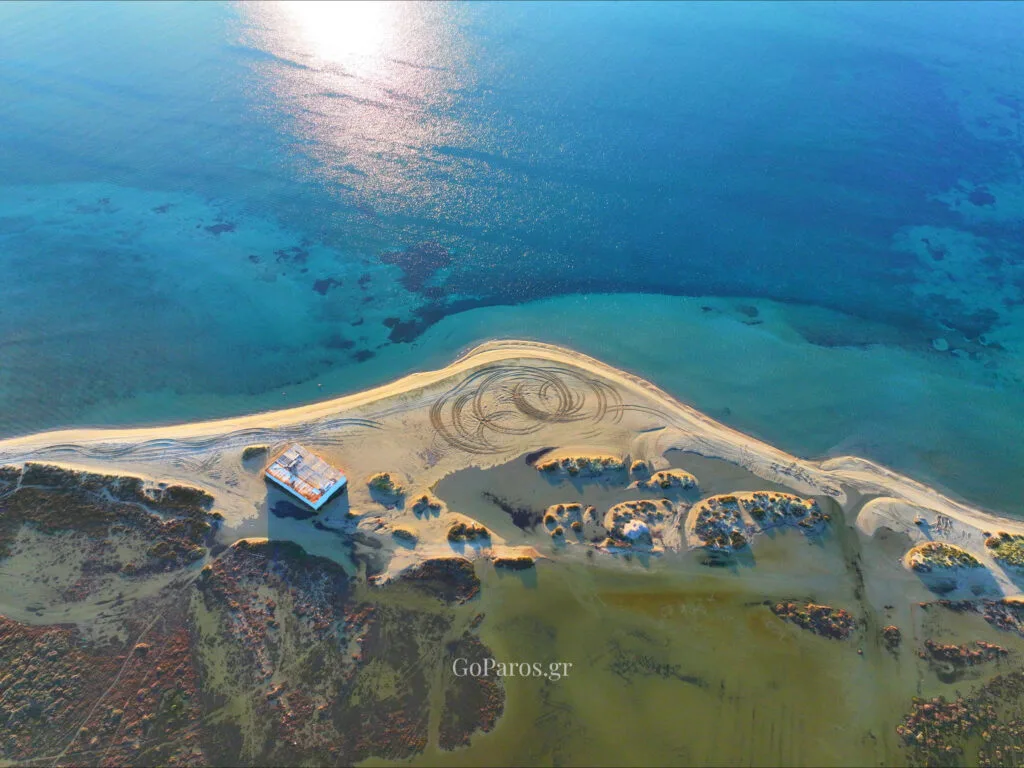 Pounda Beach West, Paros, aerial view of sandbar with sun reflection on the sea and beach tracks