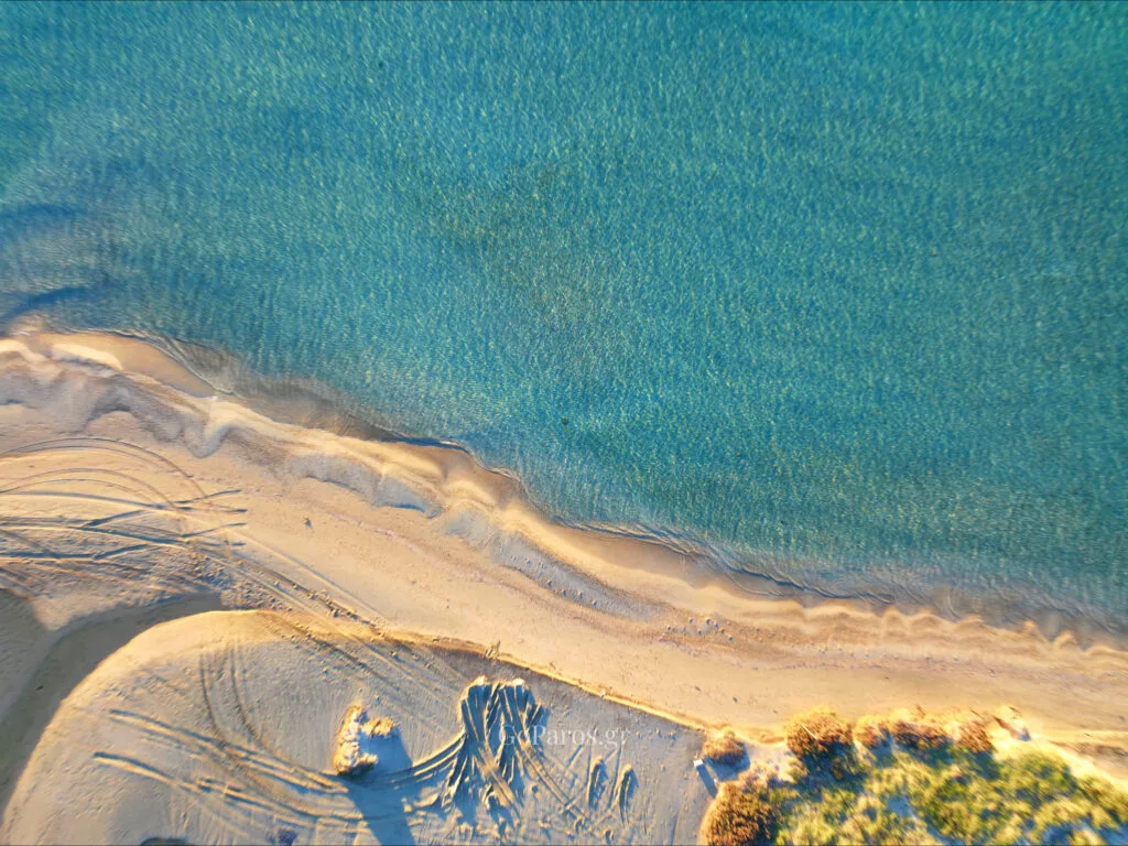 Pounda Beach West, Paros, overhead drone photo of shoreline with clear shallow water and sand