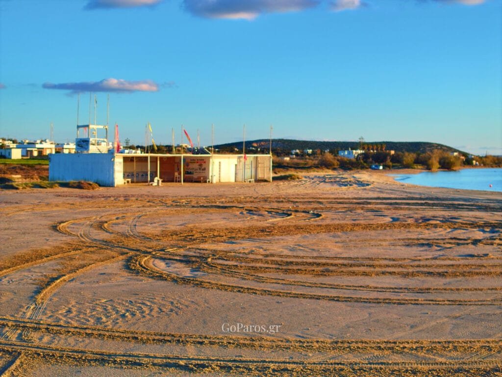 Pounda Beach West, Paros, beach scene near the facilities with flags and sandy track marks