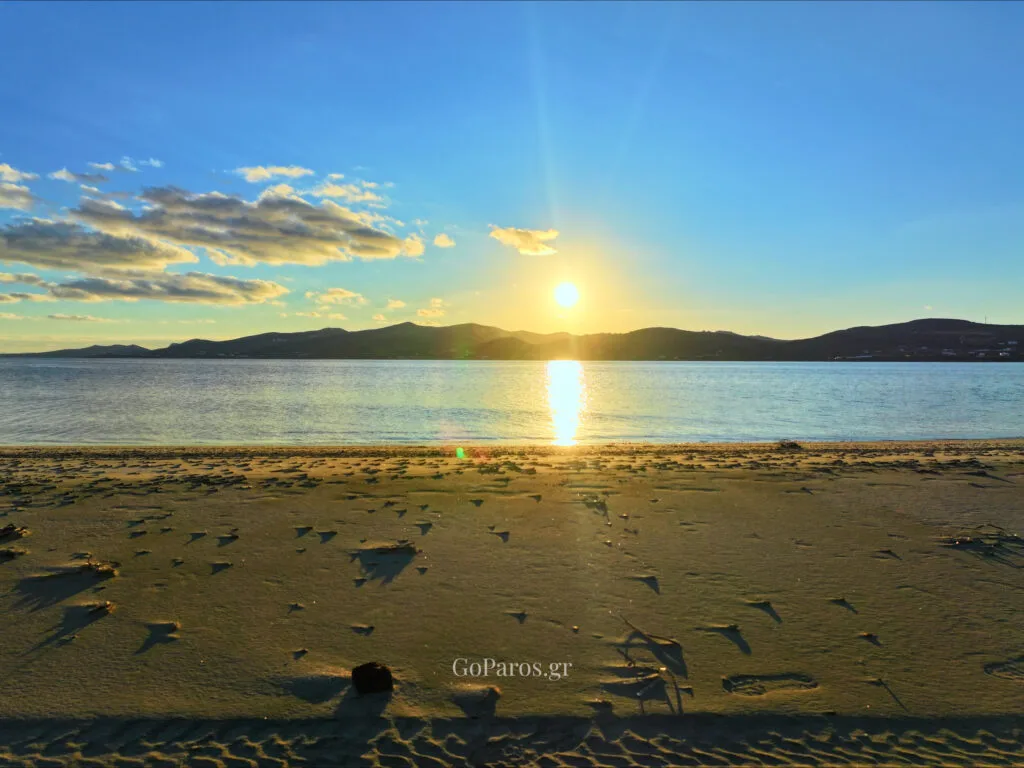 Pounda Beach West, Paros, sunset over the water from the beach with sun reflection