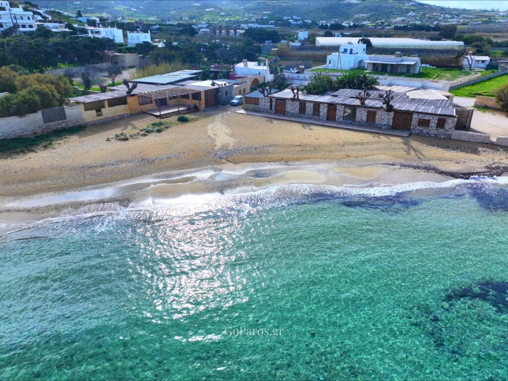 Aerial view of shallow water and shoreline at Delfini Beach, Paros.