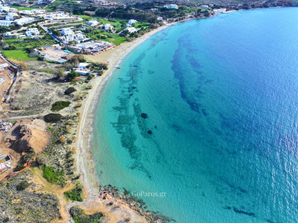 High aerial view of Krios Beach bay with turquoise water and shoreline, Paros.