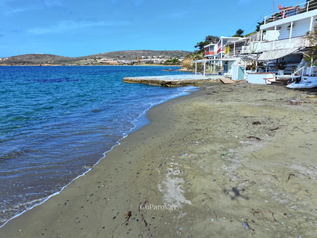 Seafront buildings beside the sandy shoreline at Krios Beach, Paros.