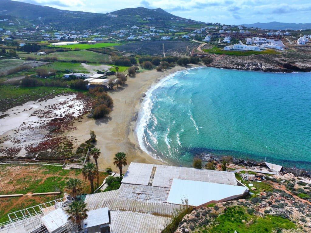 Aerial view of Parasporos Beach bay with hillside landscape in the background, Paros.