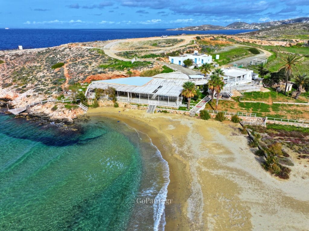 Aerial view of a small cove and bar at Parasporos Beach with clear water, Paros.