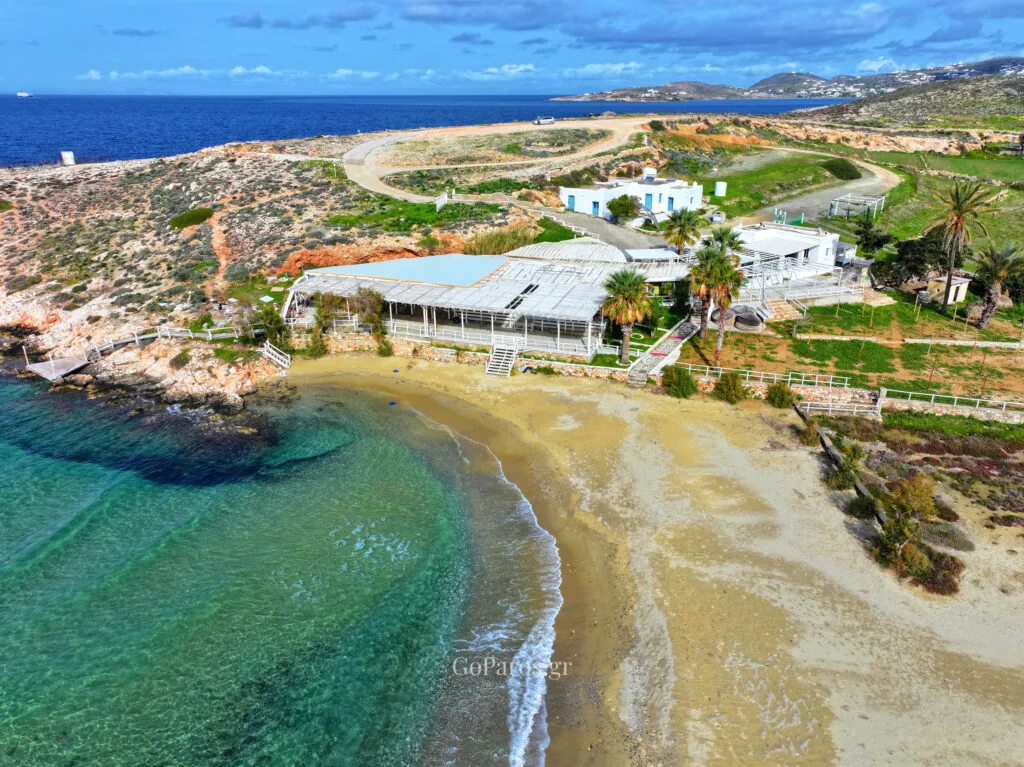 Aerial view of a small cove and bar at Parasporos Beach with clear water, Paros.
