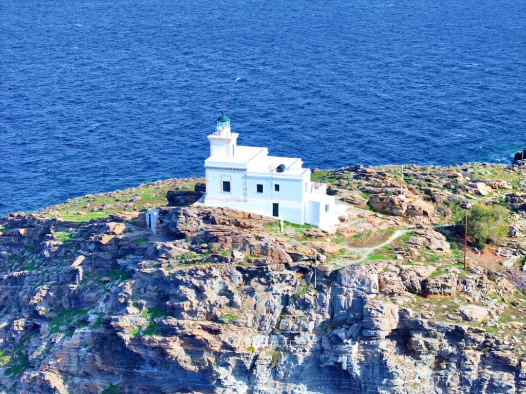 Close-up aerial of the Paros Park lighthouse on the cliffs, Paros.