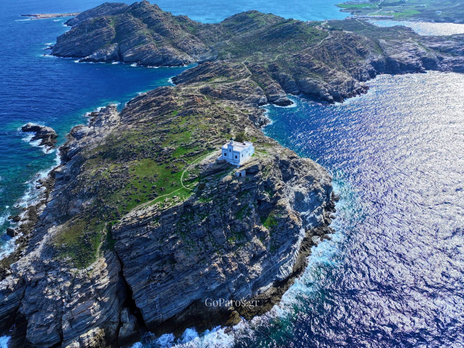 Wide aerial view of the Paros Park lighthouse and peninsula, Paros.