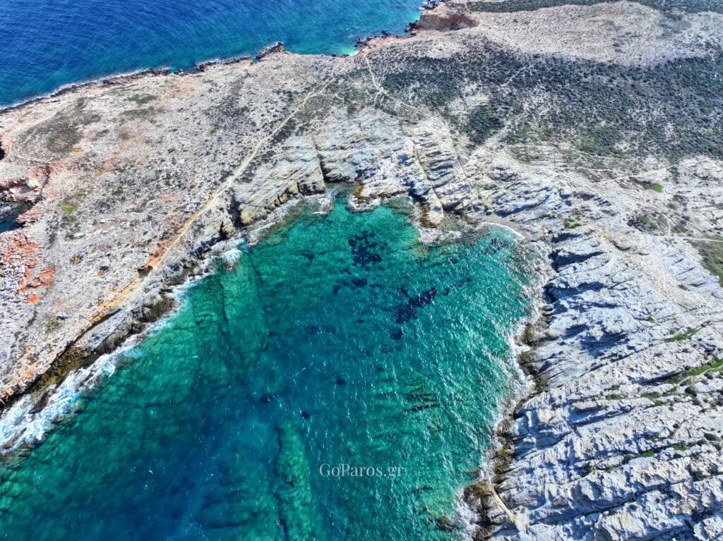 Top-down view of a turquoise cove at Paros Park, Paros.