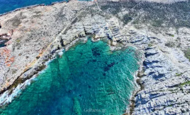 Top-down view of a turquoise cove at Paros Park, Paros.