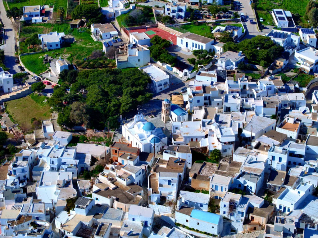 Aerial view of whitewashed houses and the village center of Kostos, Paros