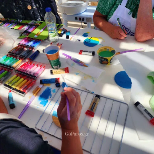 Guests painting handmade clay keepsakes during a pottery class in Paros