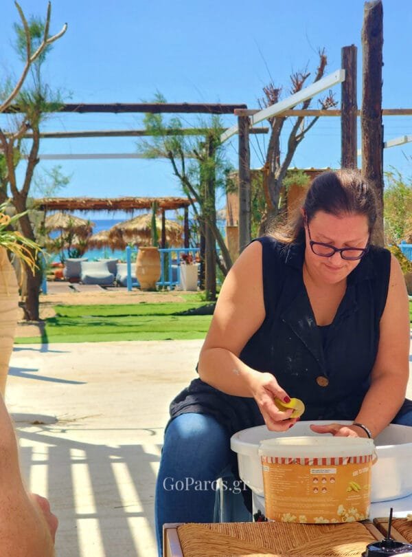 Pottery instructor demonstrating clay preparation during a workshop in Paros