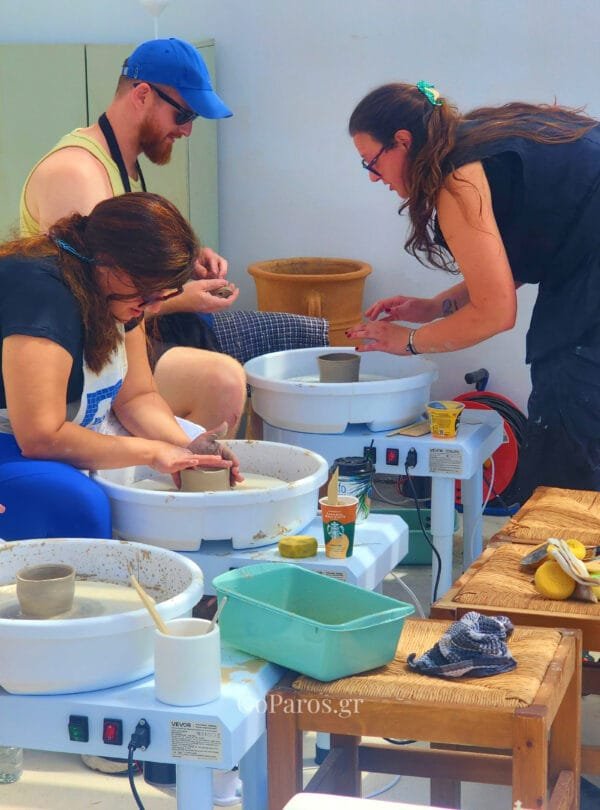 Guests learning pottery wheel techniques during a class on Golden Beach in Paros
