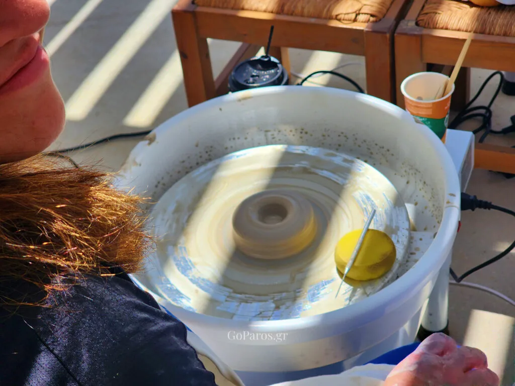Clay spinning on the pottery wheel during a hands-on workshop in Paros