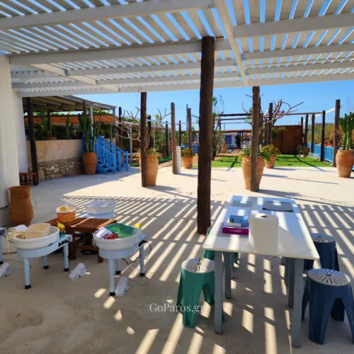 Outdoor pottery workshop setup by the sea on Golden Beach in Paros