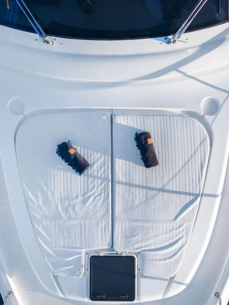 Bow sunpad towels on a Ferretti 46, private yacht cruise in Paros.