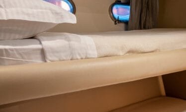Bunk bed cabin on a Ferretti 46 yacht, private yacht cruise in Paros.