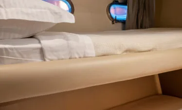 Bunk bed cabin on a Ferretti 46 yacht, private yacht cruise in Paros.