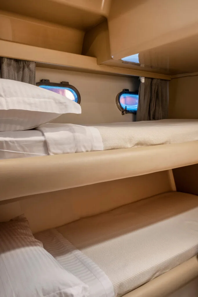 Bunk bed cabin on a Ferretti 46 yacht, private yacht cruise in Paros.