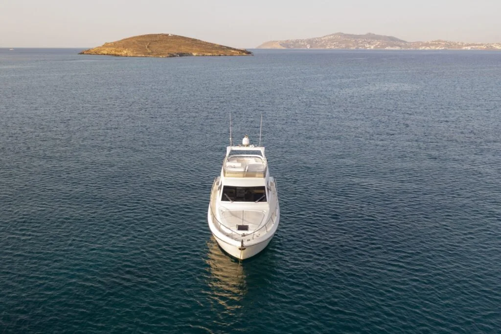 Front view of a Ferretti 46 on calm sea, private yacht cruise in Paros.